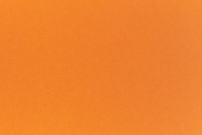 Bright neon orange cardstock paper sample. 