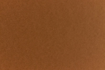 Brown crafting paper with a speckled appearance. 